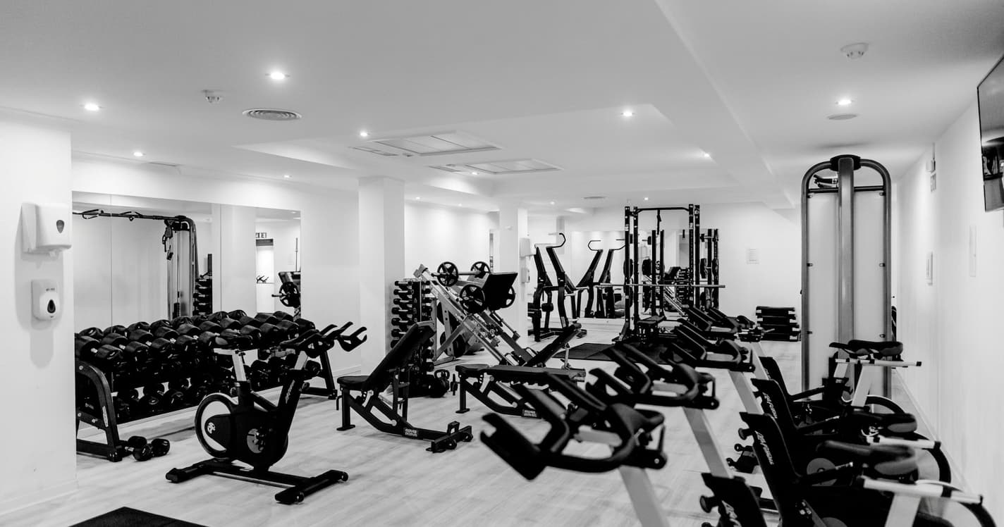 wide view of a strength gym, black and white